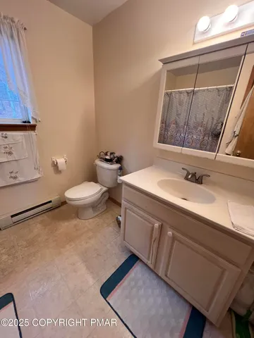a bathroom with a sink a toilet and a mirror
