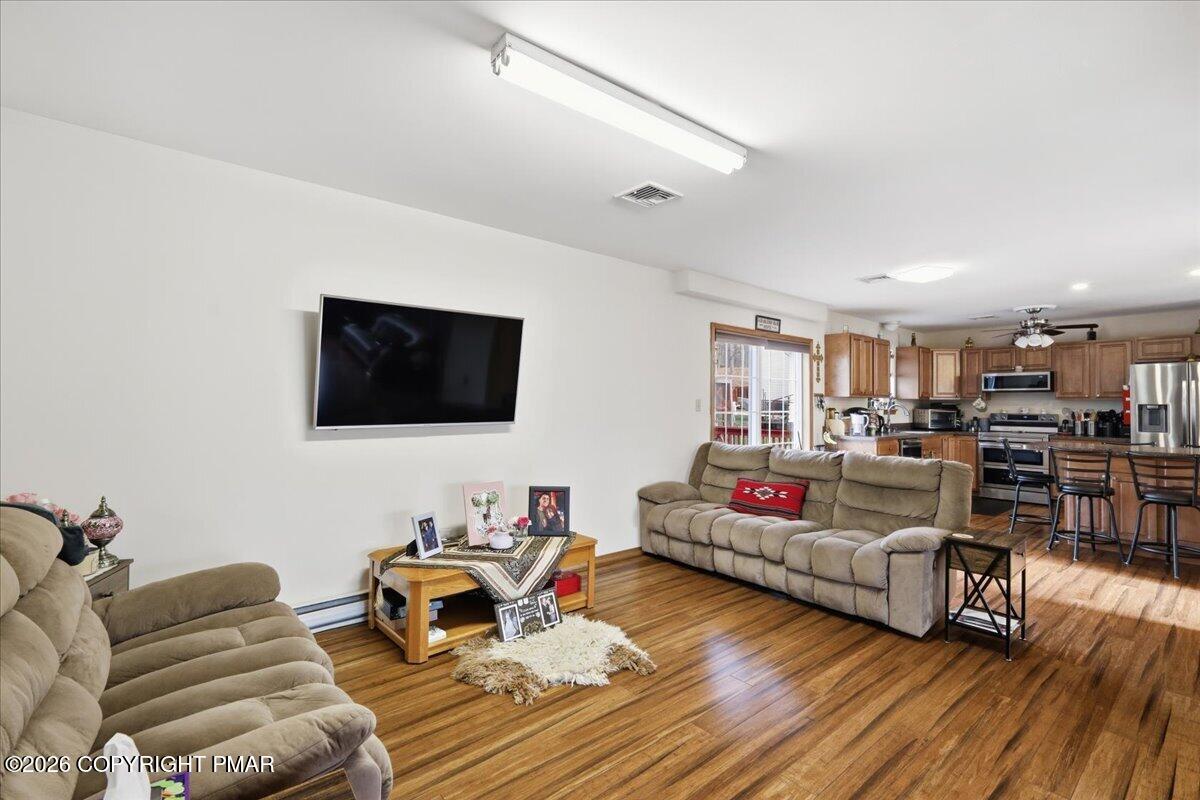4373 Pine Ridge Drive East Bushkill, PA 18324 - Photo 20 of 33 a living room with furniture and a flat screen tv