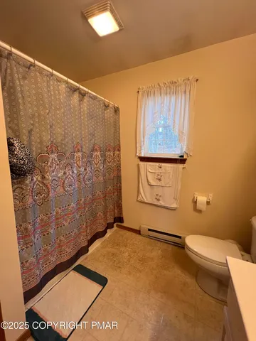 a bathroom with a shower and a toilet