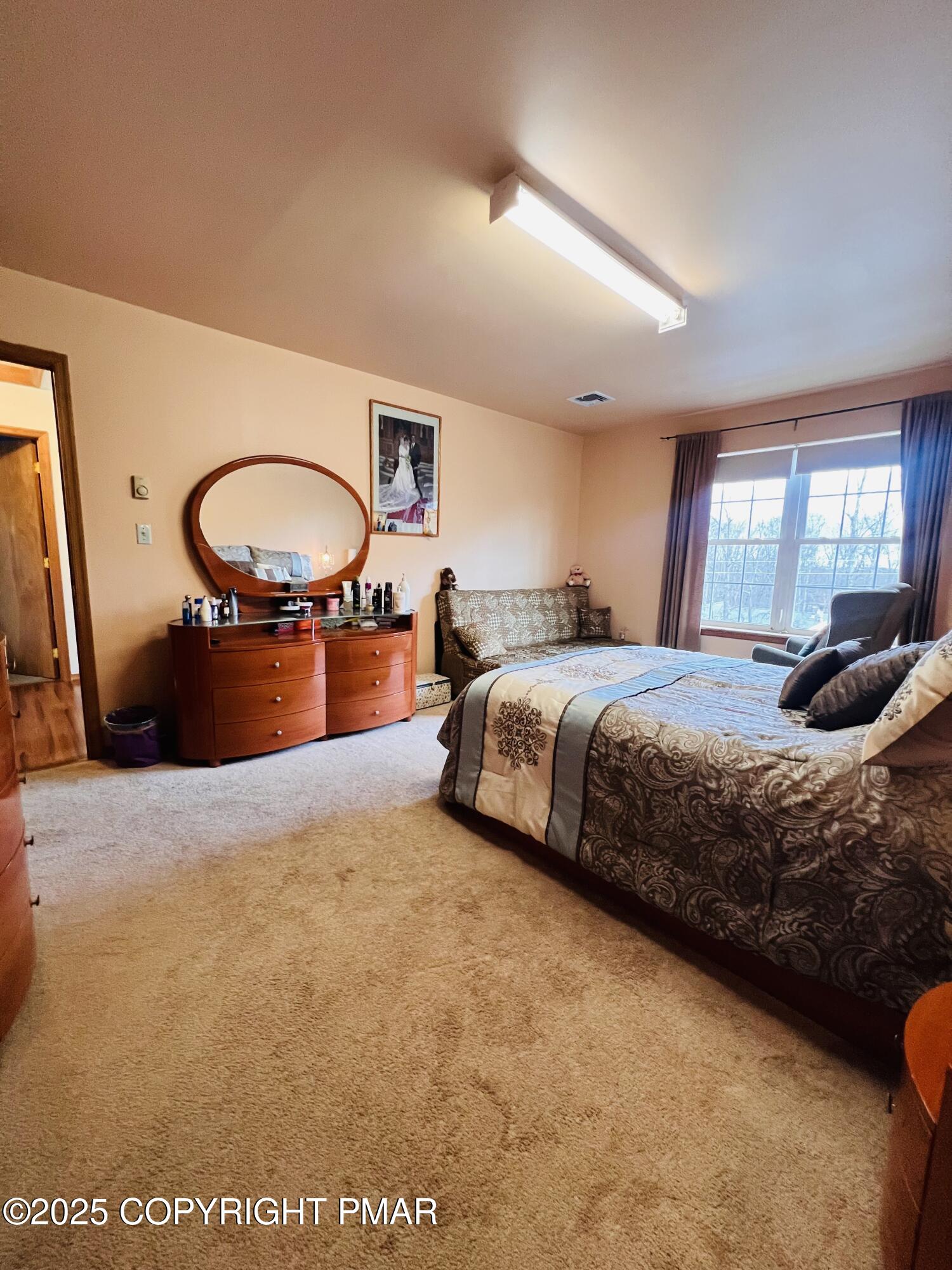 4373 Pine Ridge Drive East Bushkill, PA 18324 - Photo 22 of 39 a bedroom with a bed and window