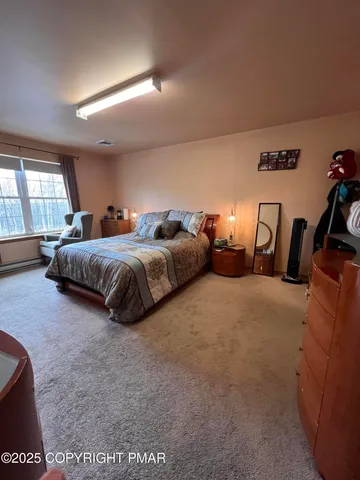 a spacious bedroom with a bed and a large mirror