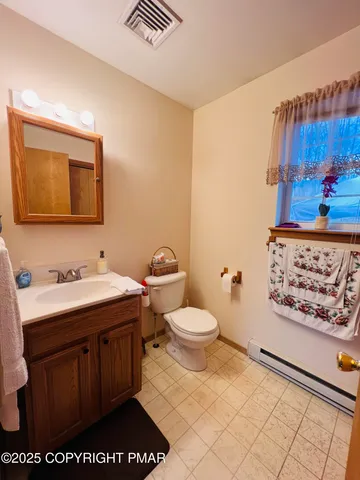 a bathroom with a toilet a sink and a mirror
