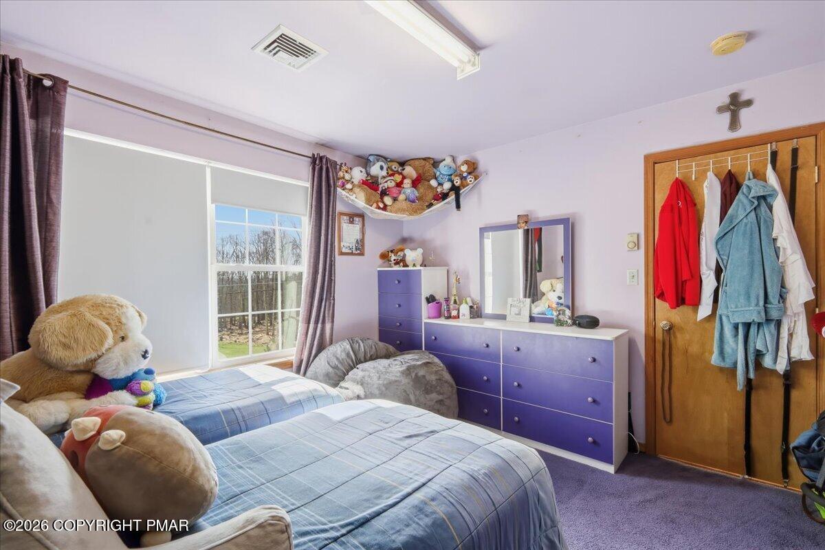 4373 Pine Ridge Drive East Bushkill, PA 18324 - Photo 29 of 33 a bedroom with a bed and a window