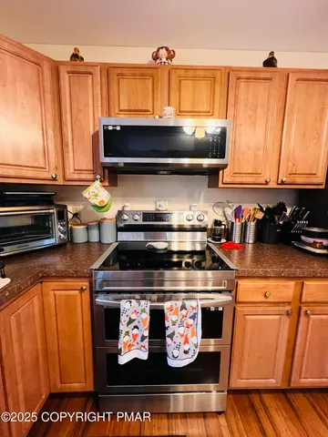 a stove top oven sitting inside of a kitchen
