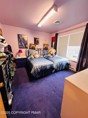 a bedroom with bed and glass door