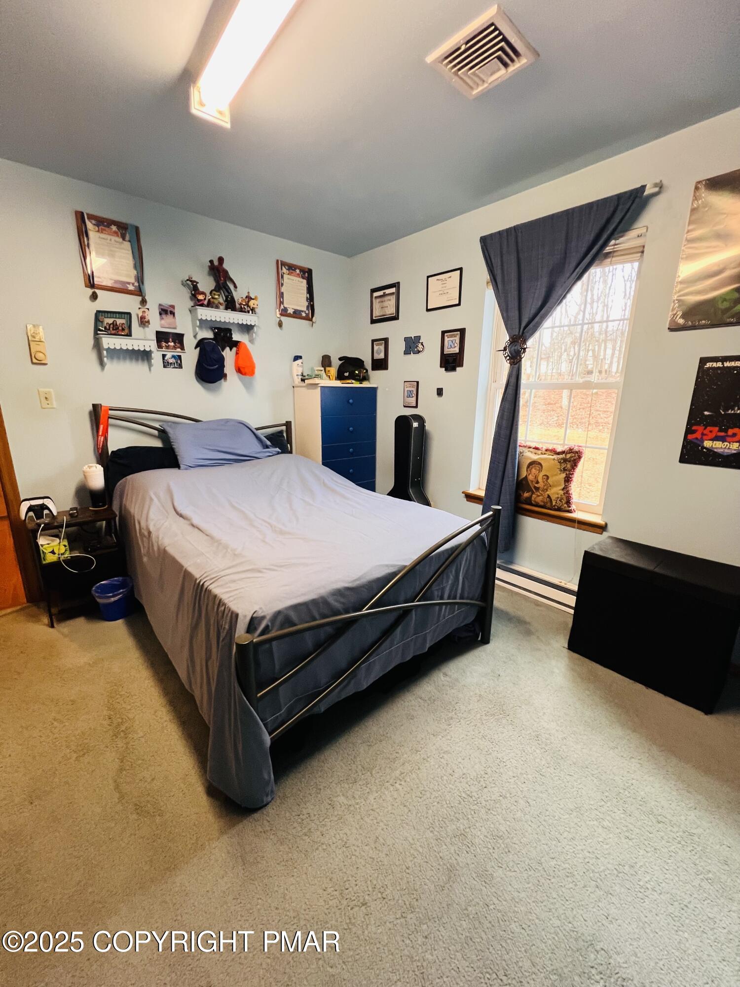 4373 Pine Ridge Drive East Bushkill, PA 18324 - Photo 34 of 39 a bed sitting in a bedroom next to a window