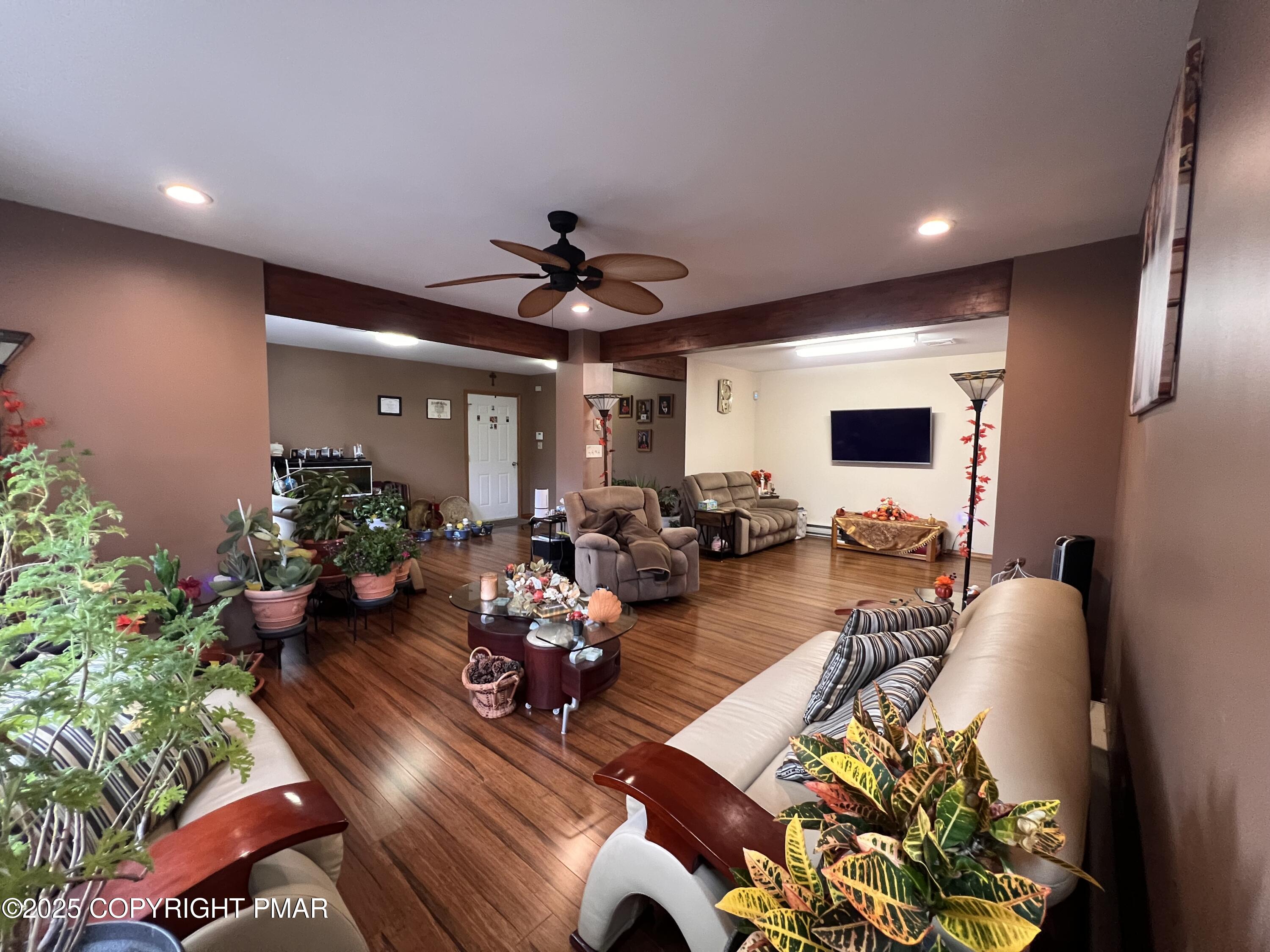 4373 Pine Ridge Drive East Bushkill, PA 18324 - Photo 7 of 39 a living room with furniture or wooden floor and a potted plant