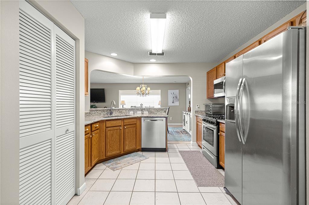 9746 Southwest 96th Street Ocala, FL 34481 - Photo 15 of 57 a large kitchen with a stove a refrigerator and a sink