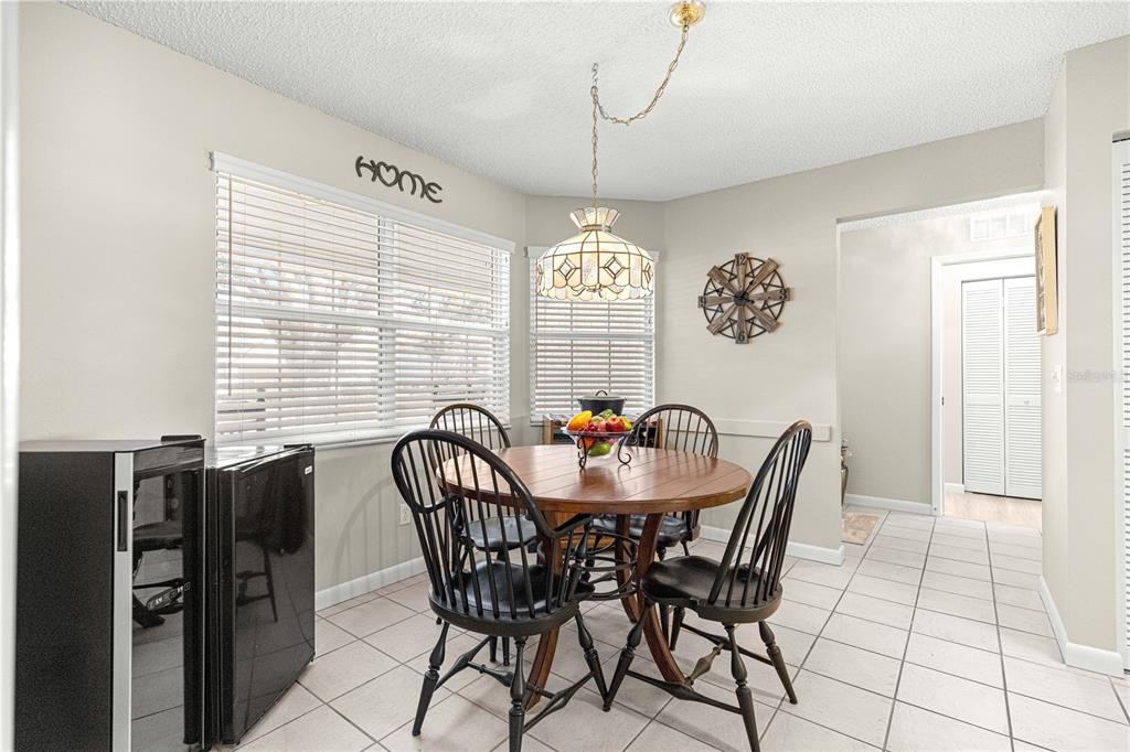 9746 Southwest 96th Street Ocala, FL 34481 - Photo 17 of 57 a view of a dining room with furniture and window