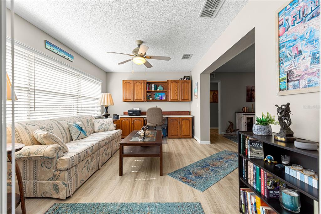 9746 Southwest 96th Street Ocala, FL 34481 - Photo 21 of 57 a living room with furniture and a flat screen tv