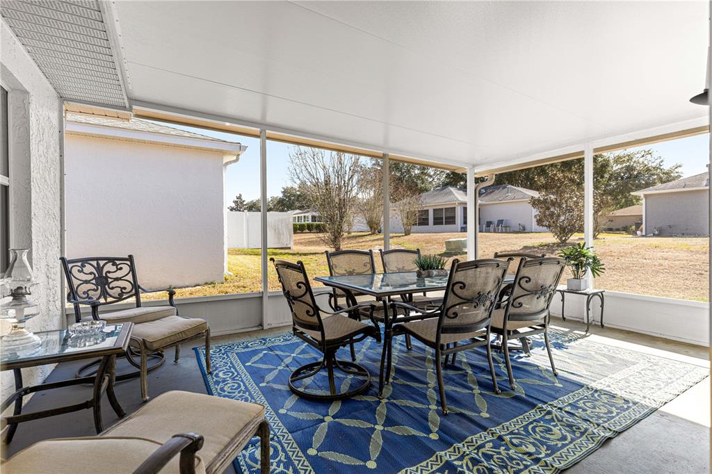 9746 Southwest 96th Street Ocala, FL 34481 - Photo 22 of 57 a view of a patio with a dining table and chairs