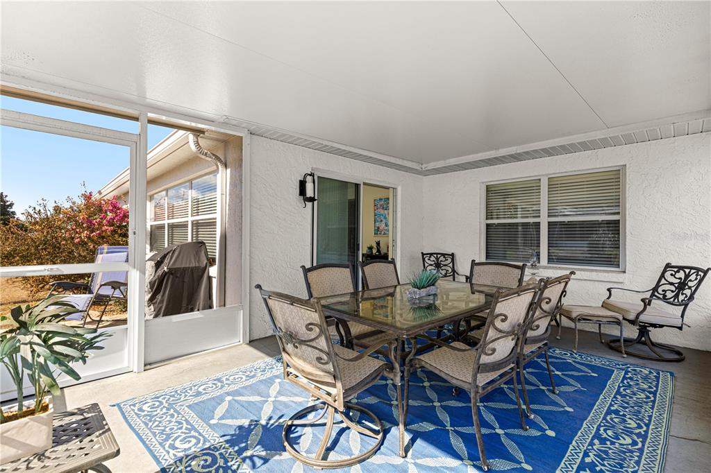 9746 Southwest 96th Street Ocala, FL 34481 - Photo 23 of 57 a view of a dining room with furniture and wooden floor