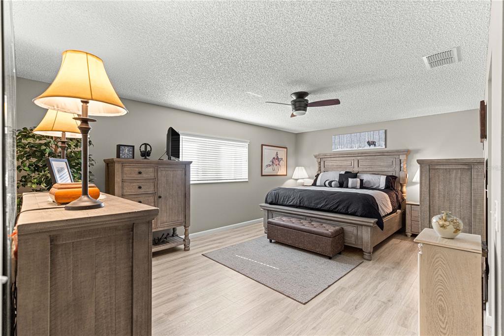 9746 Southwest 96th Street Ocala, FL 34481 - Photo 24 of 57 a bedroom with a bed and a table