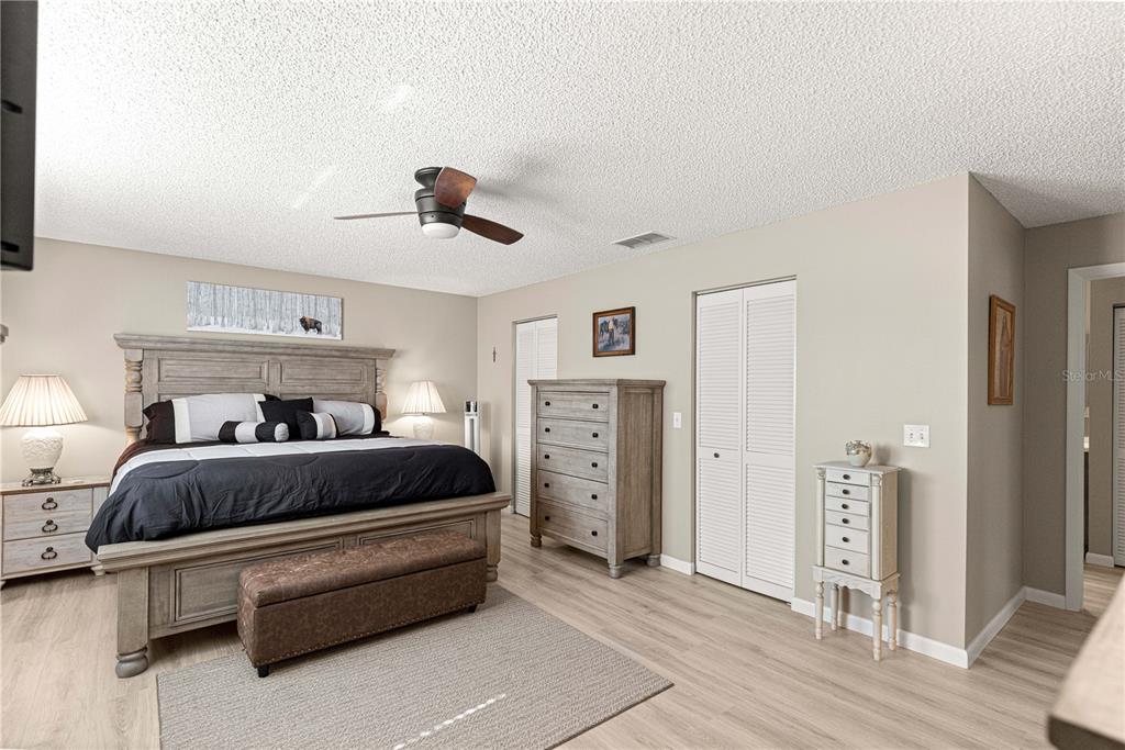 9746 Southwest 96th Street Ocala, FL 34481 - Photo 26 of 57 a spacious bedroom with a bed and cabinets