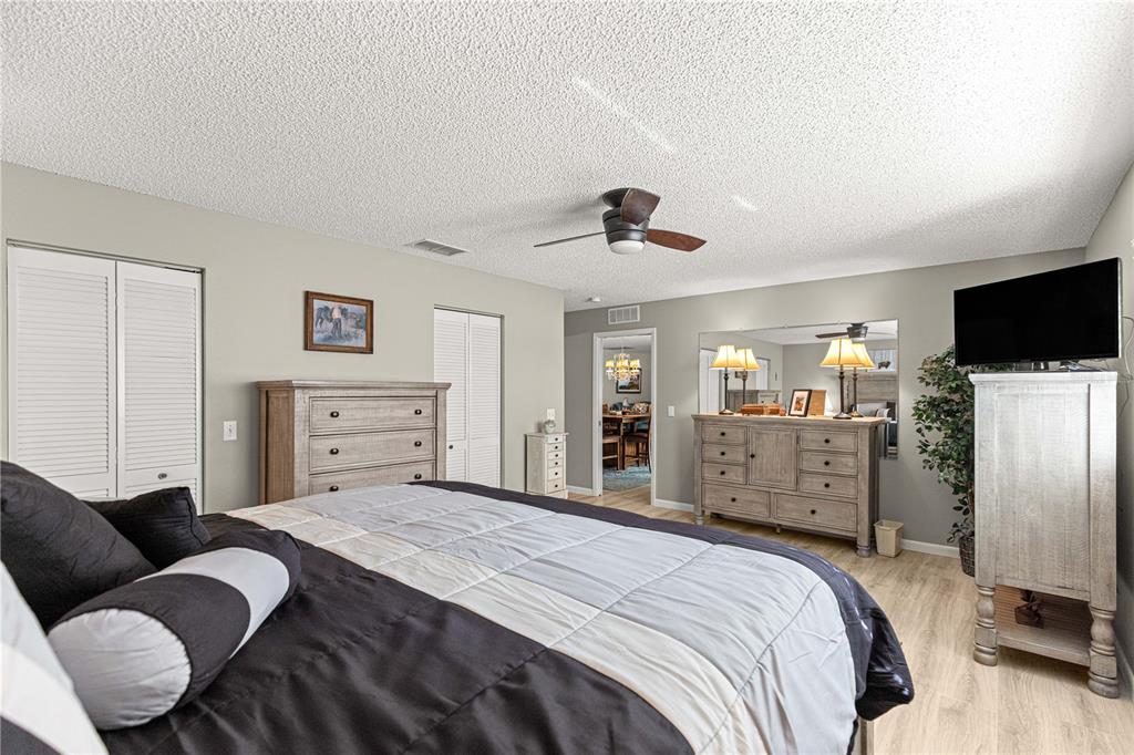 9746 Southwest 96th Street Ocala, FL 34481 - Photo 27 of 57 a bedroom with a bed and furniture