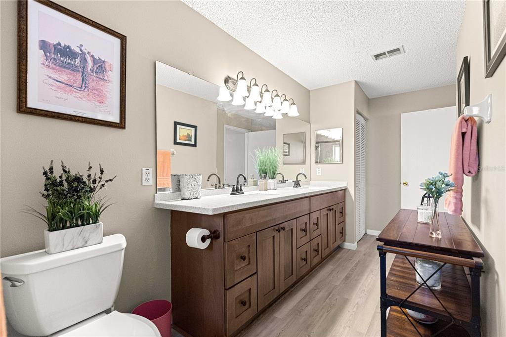 9746 Southwest 96th Street Ocala, FL 34481 - Photo 29 of 57 a bathroom with a granite countertop sink mirror and toilet