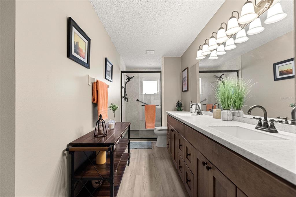 9746 Southwest 96th Street Ocala, FL 34481 - Photo 30 of 57 a spacious bathroom with a double vanity sink and a mirror