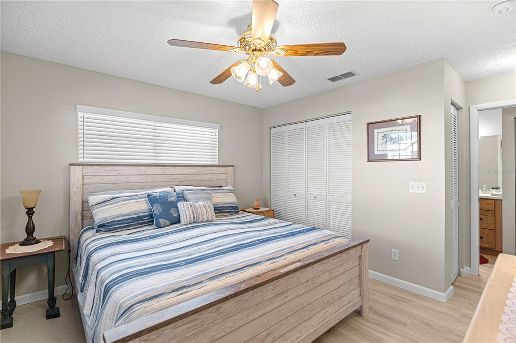 9746 Southwest 96th Street Ocala, FL 34481 - Photo 33 of 57 a bedroom with a large bed and a ceiling fan