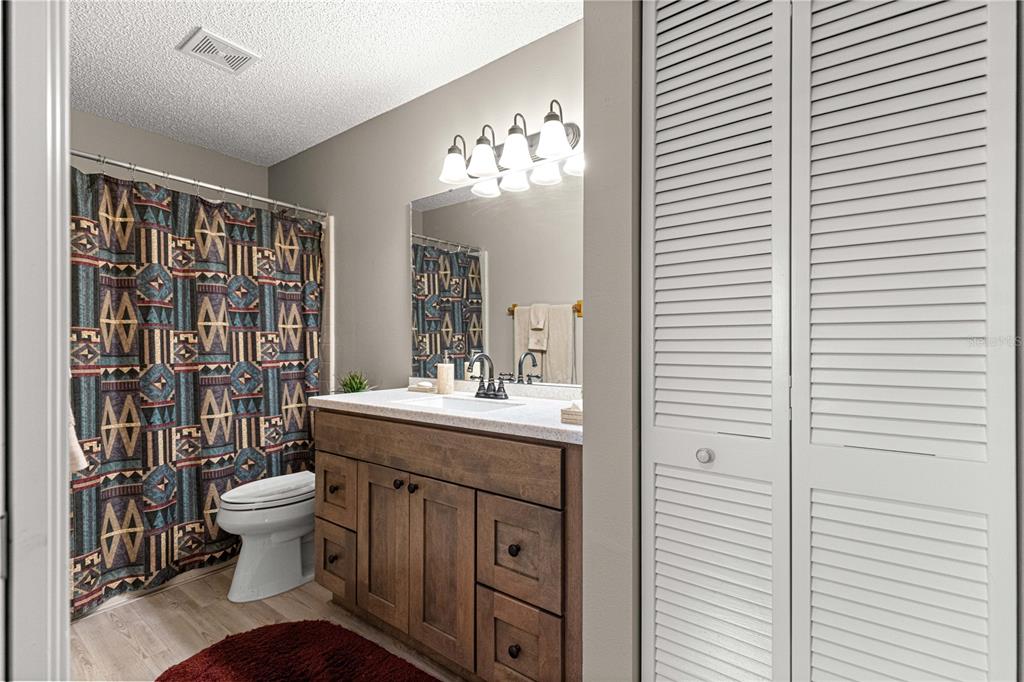 9746 Southwest 96th Street Ocala, FL 34481 - Photo 35 of 57 a bathroom with a sink a toilet and a mirror