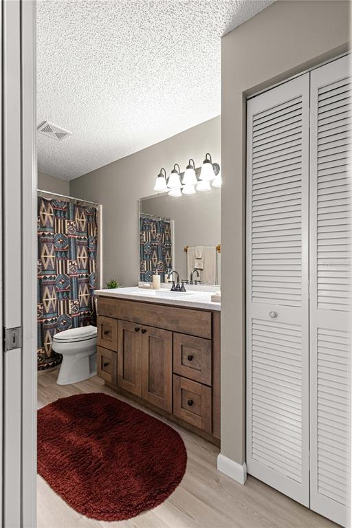 9746 Southwest 96th Street Ocala, FL 34481 - Photo 36 of 57 a bathroom with a sink a toilet and a mirror