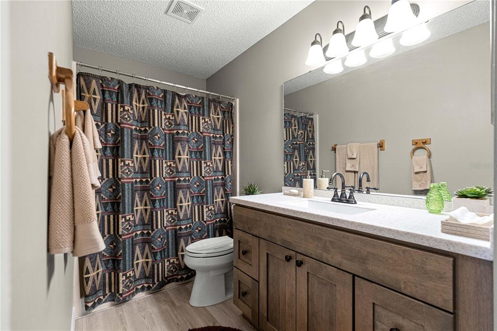 9746 Southwest 96th Street Ocala, FL 34481 - Photo 37 of 57 a spacious bathroom with a double vanity sink toilet and shower