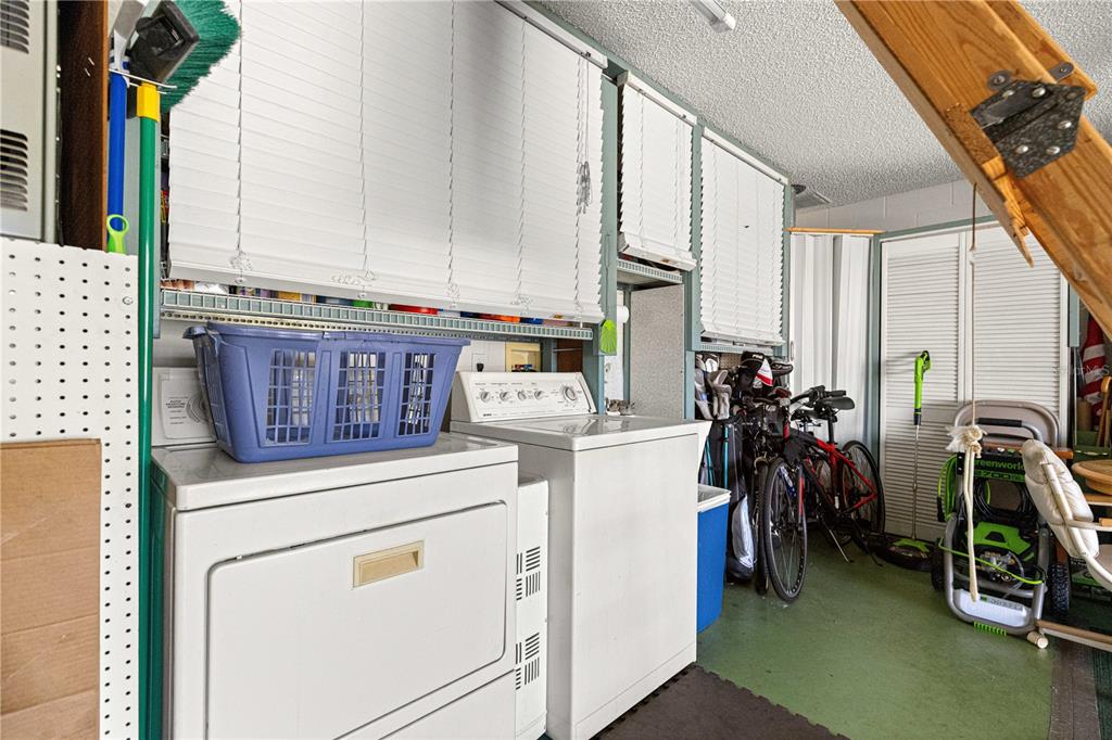 9746 Southwest 96th Street Ocala, FL 34481 - Photo 38 of 57 a view of storage and utility room with washer and dryer