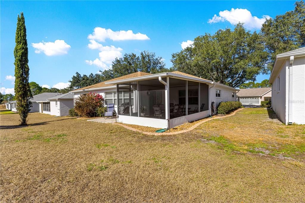 9746 Southwest 96th Street Ocala, FL 34481 - Photo 54 of 57 a view of a house with a backyard
