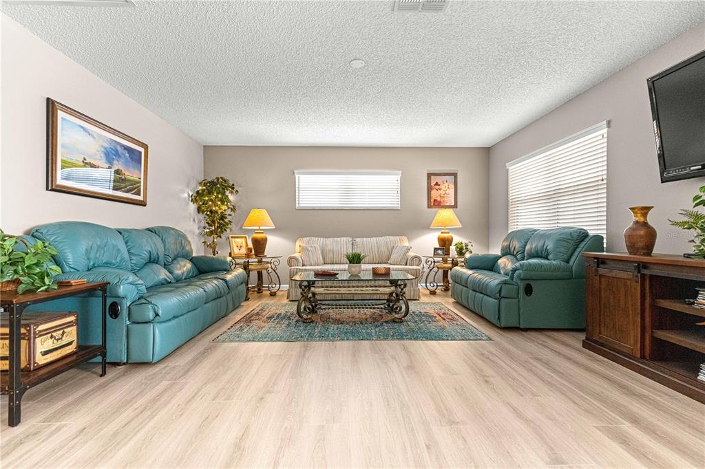 9746 Southwest 96th Street Ocala, FL 34481 - Photo 6 of 57 a living room with furniture and a fireplace