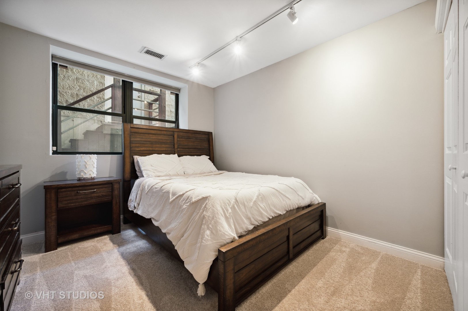 2543 North Racine Avenue, Unit G Chicago, IL 60614 - Photo 10 of 15 a bed sitting in a bedroom next to a window