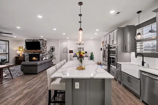 a kitchen with sink stove and wooden floor