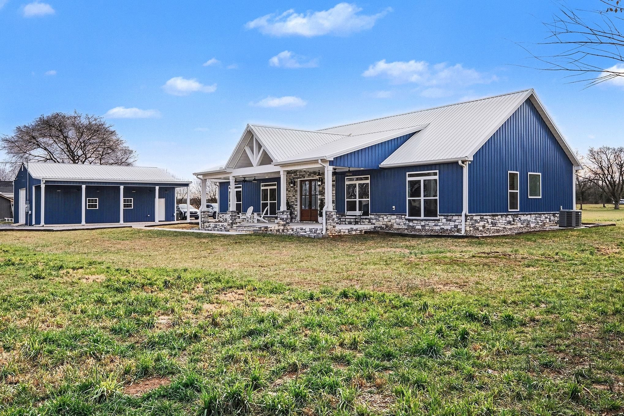 1801 Twin Caves Road Lewisburg, TN 37091 - Photo 36 of 43 a front view of a house with large windows and palm tree