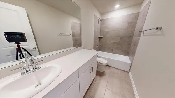a bathroom with a double vanity sink toilet and shower