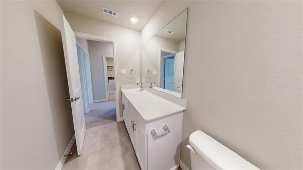 a bathroom with a sink a toilet and a mirror