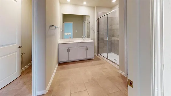 a bathroom with a granite countertop sink mirror and shower