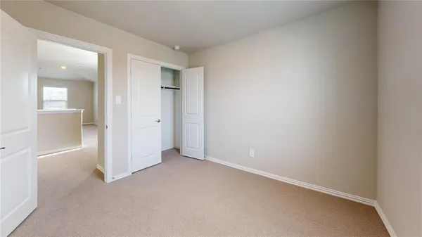 an empty room with a bathroom and a sink