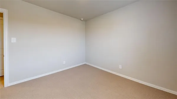 an empty room with windows and entrance