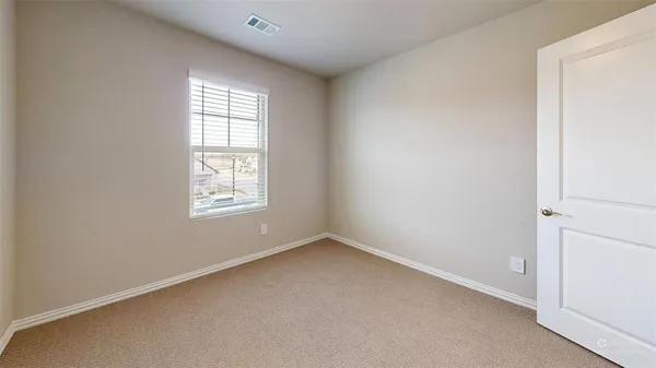 a kitchen with a refrigerator a stove top oven a sink and a window