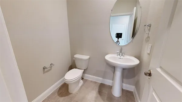 an empty room with a window and a ceiling fan