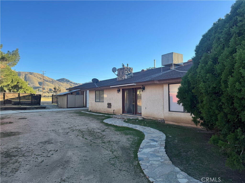 19574 Happy Valley Road Apple Valley, CA 92308 - Photo 13 of 58 a view of a house with a yard and large tree