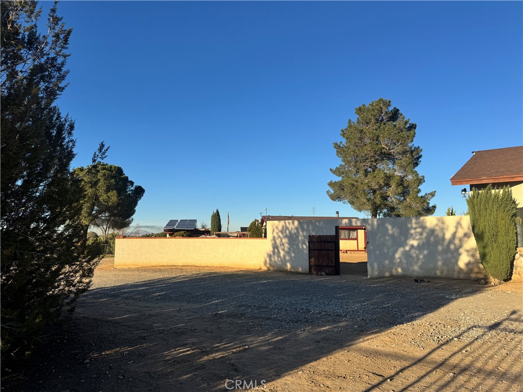 19574 Happy Valley Road Apple Valley, CA 92308 - Photo 16 of 58 a view of a yard and front view of a house