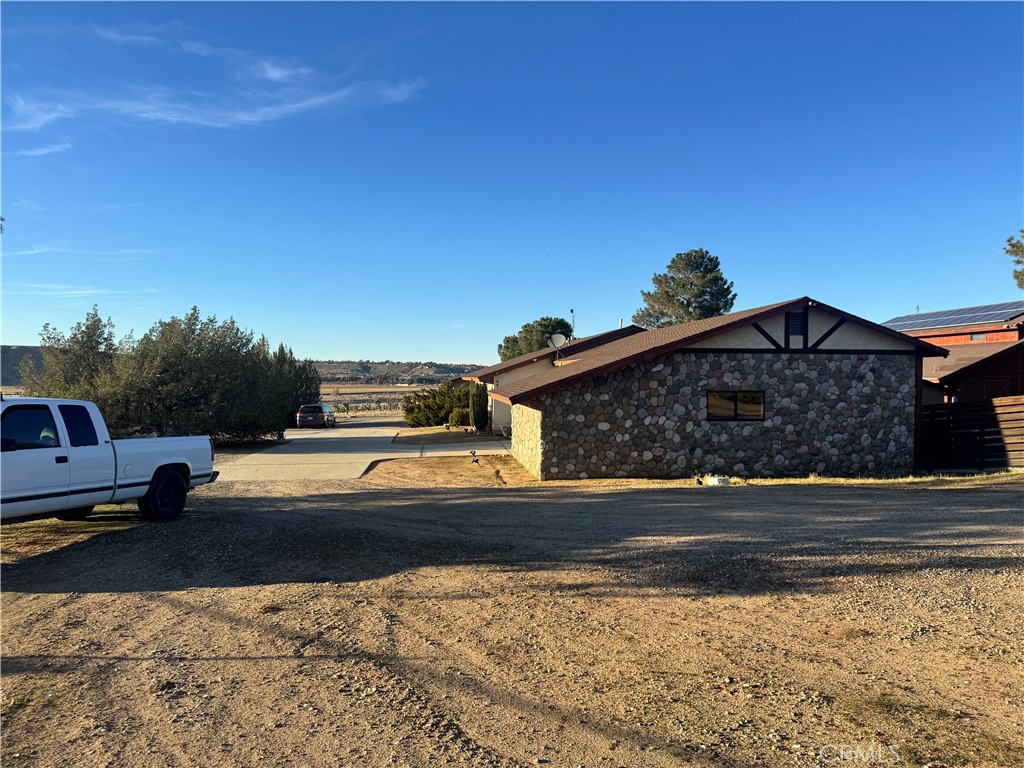 19574 Happy Valley Road Apple Valley, CA 92308 - Photo 18 of 58 a front view of a house with a yard