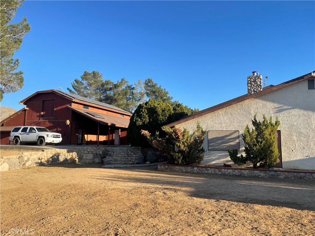 19574 Happy Valley Road Apple Valley, CA 92308 - Photo 20 of 58 a front view of a house with a yard and garage