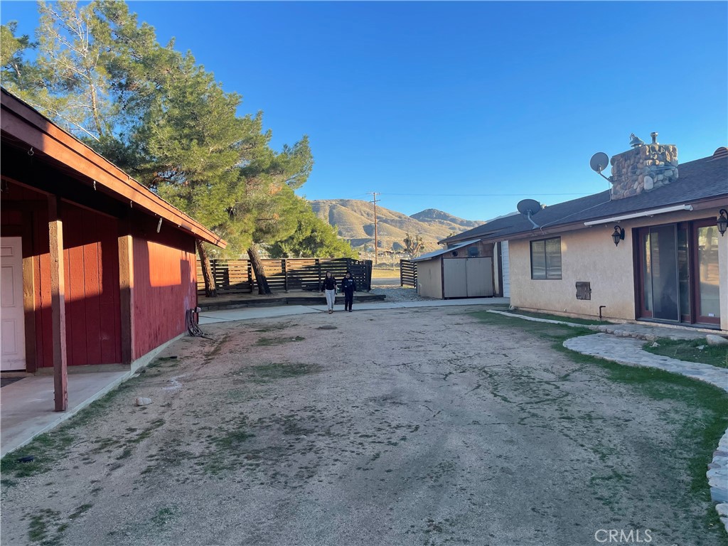19574 Happy Valley Road Apple Valley, CA 92308 - Photo 21 of 58 a view of a house with backyard and trees