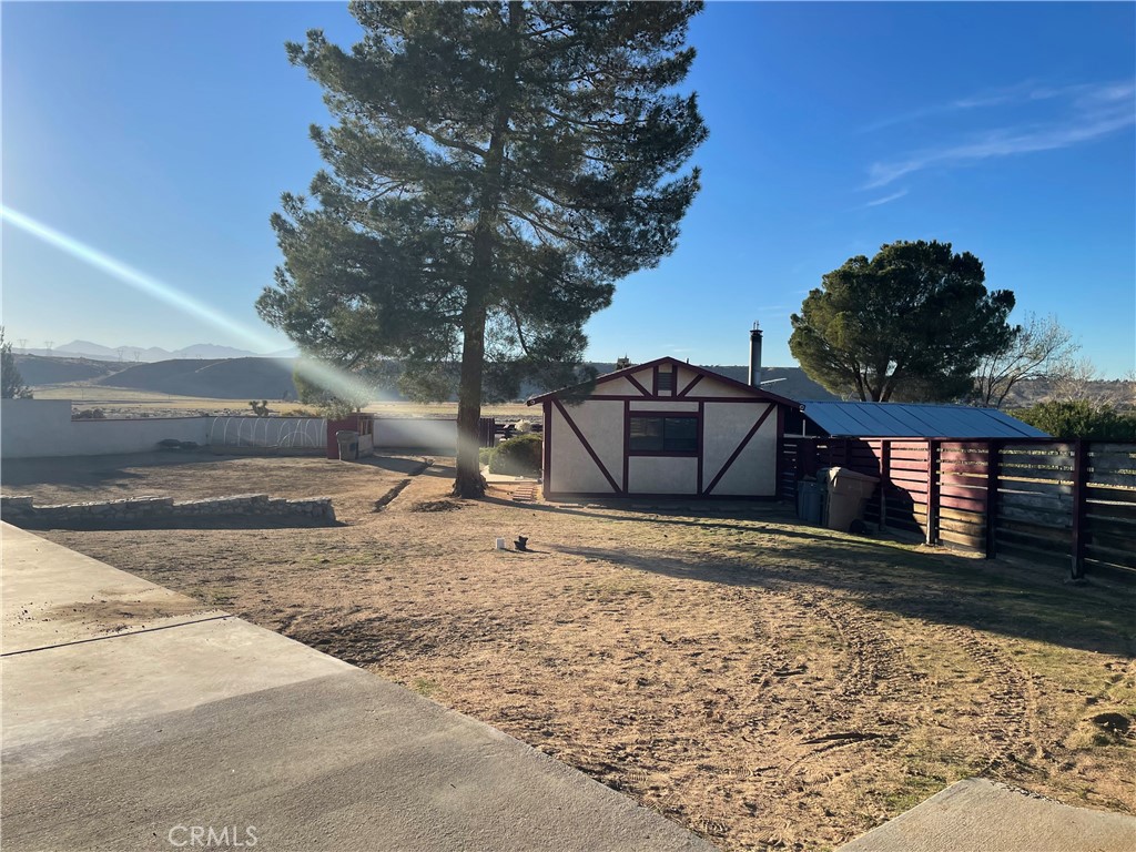 19574 Happy Valley Road Apple Valley, CA 92308 - Photo 30 of 58 a house with trees in front of it