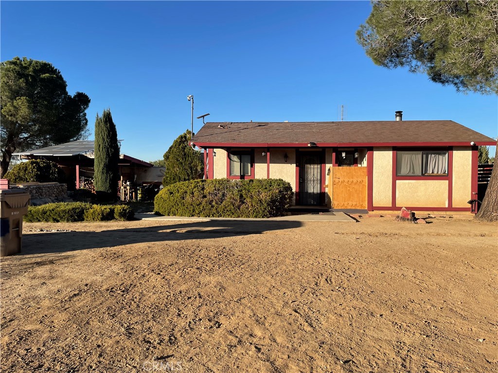 19574 Happy Valley Road Apple Valley, CA 92308 - Photo 33 of 58 a front view of a house with a yard and garage