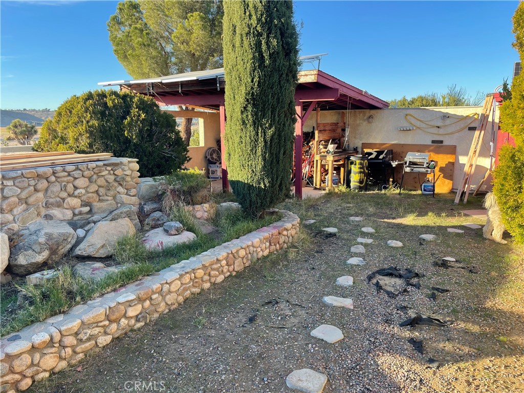 19574 Happy Valley Road Apple Valley, CA 92308 - Photo 35 of 58 a front view of a house with a yard