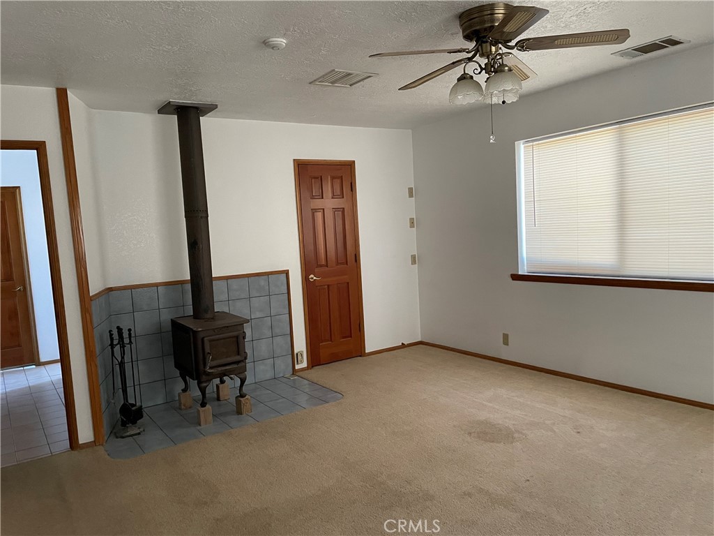 19574 Happy Valley Road Apple Valley, CA 92308 - Photo 50 of 58 wooden floor in an empty room with a window
