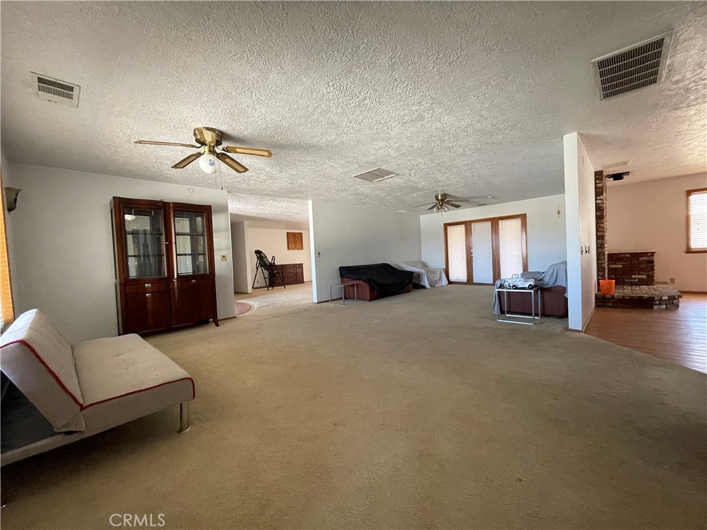 19574 Happy Valley Road Apple Valley, CA 92308 - Photo 53 of 58 a living room with furniture and a chandelier