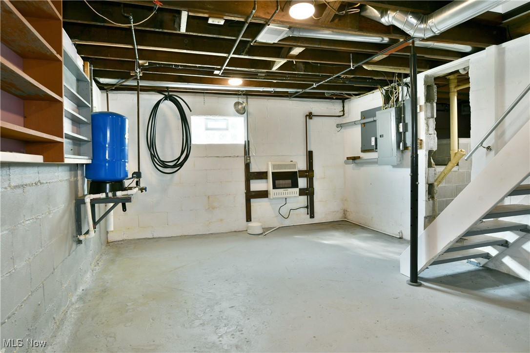 5150 Phillips Rice Road Cortland, OH 44410 - Photo 42 of 50 Basement with a water pressure tank, electric panel, stairs, and heating unit
