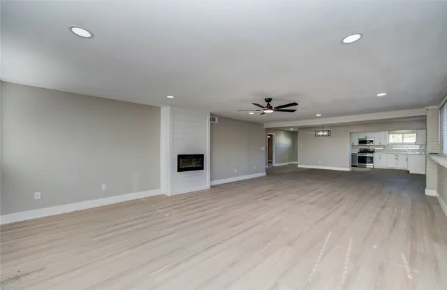 a view of a kitchen with a sink and a refrigerator